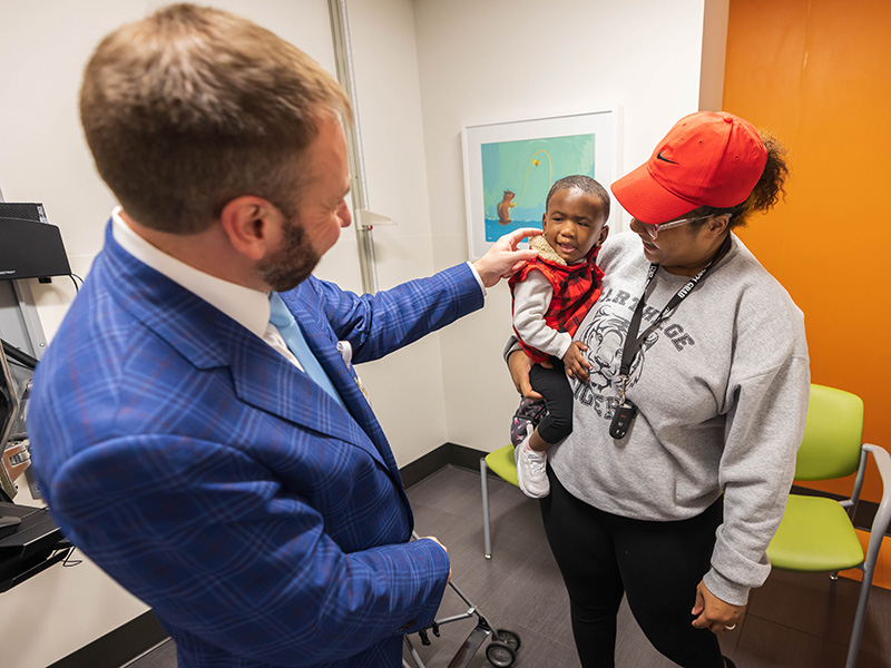 Dr. Ian Hoppe greets patient Taylor Dudley of Ridgeland and her mom, De'Andrea Morris during a follow-up visit.